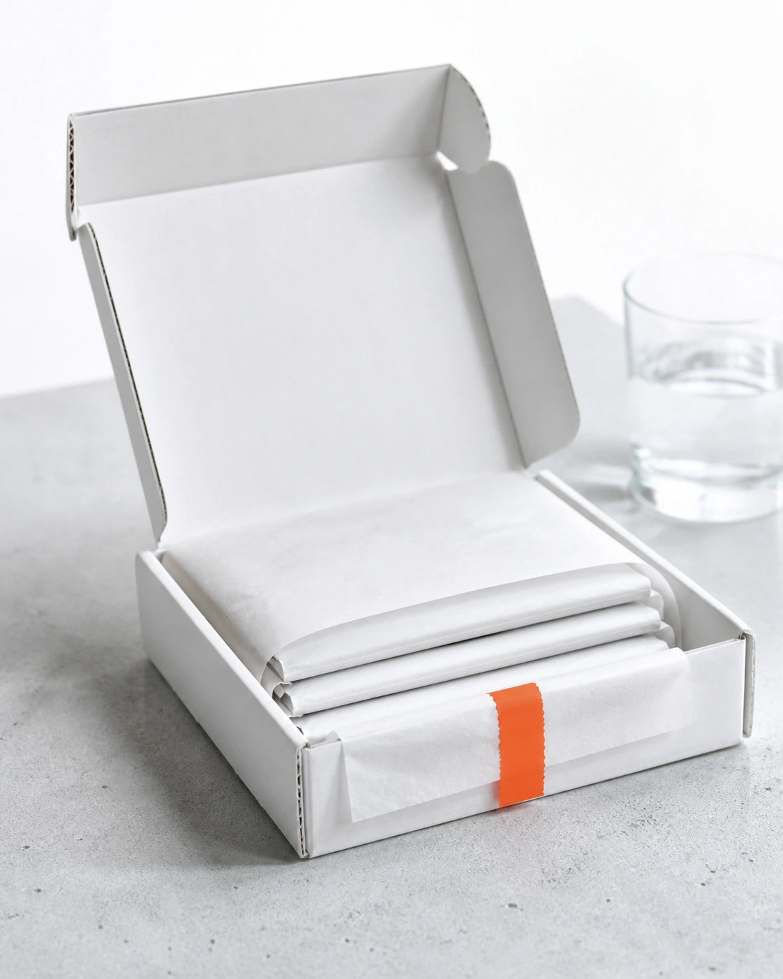 A supplement delivery being unpacked on a cool studio surface