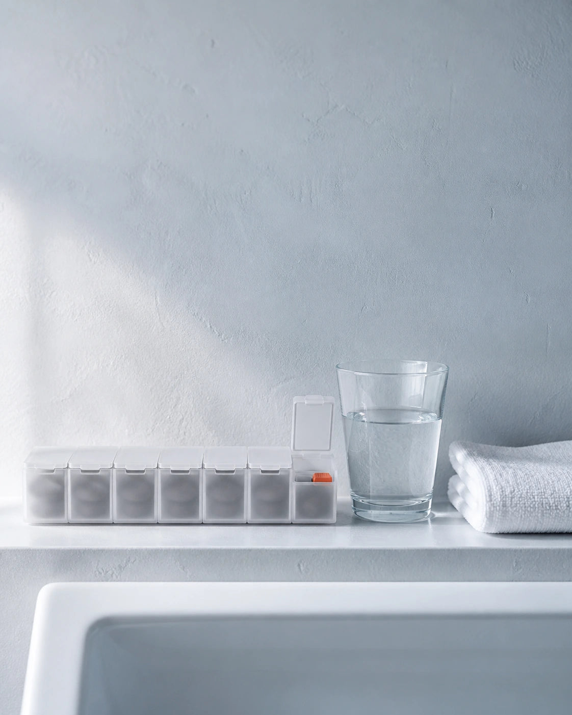 An organized daily supplement routine on a pale shelf